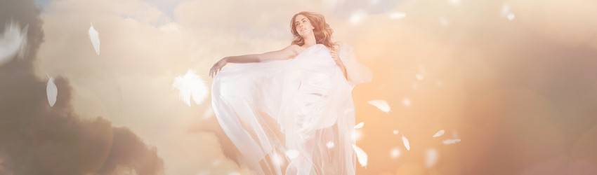 An angel sits in the clouds in a dream.