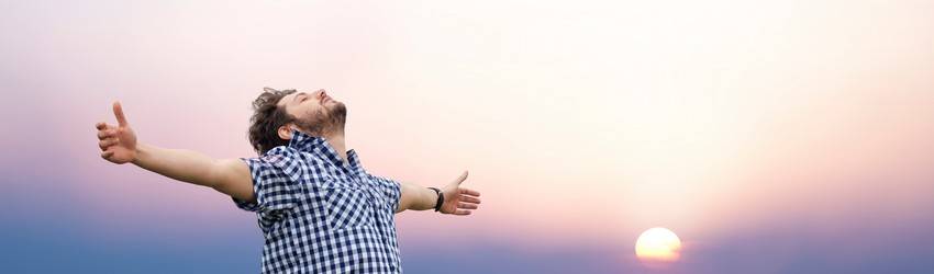 man with hands outstretched to the sky